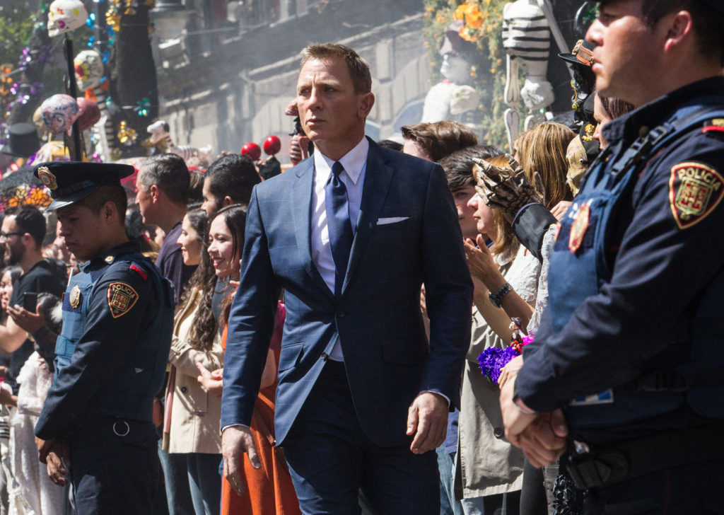 Bond (Daniel Craig) following Marco Sciarra through the Dia de los Muertos procession in Metro-Goldwyn-Mayer Pictures/Columbia Pictures/EON Productions’ action adventure SPECTRE. Tolsa Square, Mexico City.