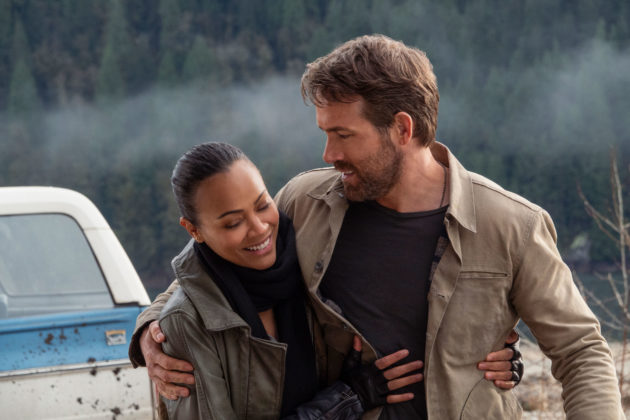 img src="TAP_20201203_01895r.jpg" alt="THE ADAM PROJECT Zoe Saldana as Laura and Ryan Reynolds as Big Adam laughing"