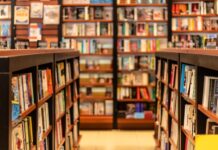 Essential Advice for Organizing Your Comic Book Store The interior of a book shop contains short bookcases full of reading material. Floor-to-ceiling bookcases line the back wall.