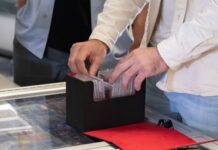 Most Valuable Basketball Cards of All Time A sports card collector looks through a vendor's cards, searching for valuable basketball cards.
