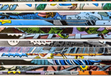 Insurance Tips for Collectors and Hobbyists A close-up of a stack of vintage comic books with colorful, illustrated covers partially visible along the edges.